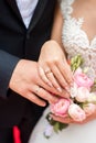 Newlyweds ` hands with rings. Wedding bouquet on the background of the hands of the bride and groom with a gold ring Royalty Free Stock Photo