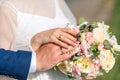 Newlyweds ` hands with rings. Wedding bouquet on the background of the hands of the bride and groom with a gold ring Royalty Free Stock Photo