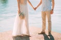 Newlyweds hold hands on the sea. Couple holding hands. Wedding i Royalty Free Stock Photo