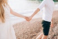 Newlyweds hold hands on the sea. Couple holding hands. Wedding i Royalty Free Stock Photo