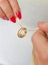 Newlyweds hold wedding rings on a string Royalty Free Stock Photo