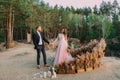 Newlyweds holding hands, laugh and smile, happy and joyful moment. Bride and groom walking on nature. Outdoors wedding Royalty Free Stock Photo