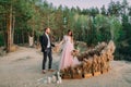 Newlyweds holding hands, laugh and smile, happy and joyful moment. Groom is looking on his beautiful bride. Outdoors Royalty Free Stock Photo