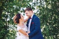 Newlyweds hug and laugh at the river bank