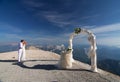 The newlyweds kiss near the wedding arch