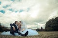 Newlyweds kiss in a park