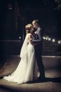 Newlyweds kiss under the lantern at night