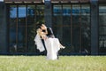 Newlyweds kiss under a veil on background willow