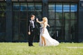 Newlyweds kiss under a veil on background willow