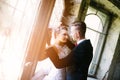 Newlyweds kissing near old door