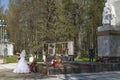 Newlyweds laying flowers at the monument of Glory