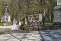 Newlyweds laying flowers at the monument of Glory