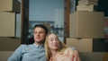 Newlyweds moving new flat enjoying own property closeup. Couple sitting on couch Royalty Free Stock Photo