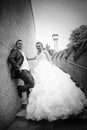 Newlyweds posing on stone steps bw