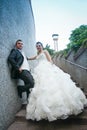 Newlyweds posing on stone steps