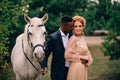 Newlyweds are standing near a white horse Royalty Free Stock Photo