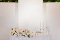 The newlyweds' table area is decorated with flowers and candles and illuminated with white light Royalty Free Stock Photo