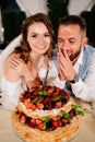 newlyweds with a traditional wedding cake. End of the holiday. Royalty Free Stock Photo