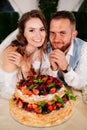newlyweds with a traditional wedding cake. End of the holiday. Royalty Free Stock Photo
