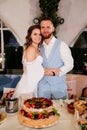 newlyweds with a traditional wedding cake. End of the holiday. Royalty Free Stock Photo