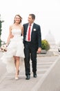 Newlyweds walking in the street. Royalty Free Stock Photo