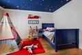 Childs bedroom with bed, wigwam and stars on the ceiling