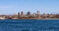 Newport Beach California city skyline with snow with snow capped mountains in background