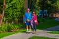 Senior citizen male caucasian baby boomer with Alzheimer`s Disease wearing shorts and high white athletic socks being helped to