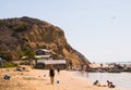 A landscape view of the beach and large cliff at Crystal Cove in Newport Coast, California