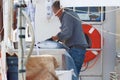 Fisherman cleans fish on boat Royalty Free Stock Photo