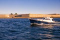 A boat sails past the historic Fort Adams