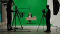 News anchor at work, woman journalist presenter telling breaking news, view of a backstage studio TV news shooting