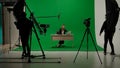 News anchor at work, woman journalist presenter telling breaking news, view of a backstage studio TV news shooting