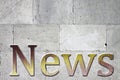 News carved on white stone wall - concept image with upper space for text