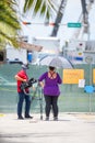 News crew on site by the fence at the Champlain Towers collapse site