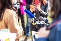 News or press conference microphone in focus, mobile journalist filming media event with a smartphone Royalty Free Stock Photo