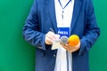 News reporter or broadcast journalist at press conference or media event, holding microphone, taking notes Royalty Free Stock Photo