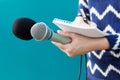 News reporter or TV journalist at press conference, holding microphone and writing notes Royalty Free Stock Photo