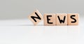 News symbol. Concept word News on wooden cubes. Beautiful white background. Business and News concept. Copy space