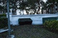 NEWS Ã¢â¬â Waterline along a fence with a waterlogged dumpster pushed against the cement after Hurricane Ian storm surge flooding in