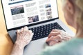 News website in laptop of an old woman. Elder senior and grandma reading digital newspaper with computer. Online magazine.