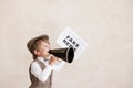 Newsboy shouting against grunge wall background. Boy selling fake news