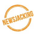 NEWSJACKING text written on orange grungy round stamp