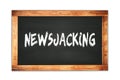 NEWSJACKING text written on wooden frame school blackboard