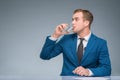 Newsman drinking water at his desk