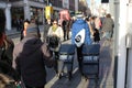 LONDON, UK - February 16, 2018: Newspaper boy dragging newspapers racks on the street.