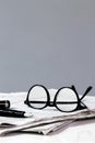 Newspaper break with Pen and Glasses Royalty Free Stock Photo