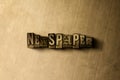 NEWSPAPER - close-up of grungy vintage typeset word on metal backdrop