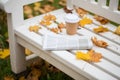 Newspaper and coffee cup on bench in autumn park Royalty Free Stock Photo