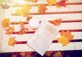 Newspaper and coffee cup on bench in autumn park Royalty Free Stock Photo